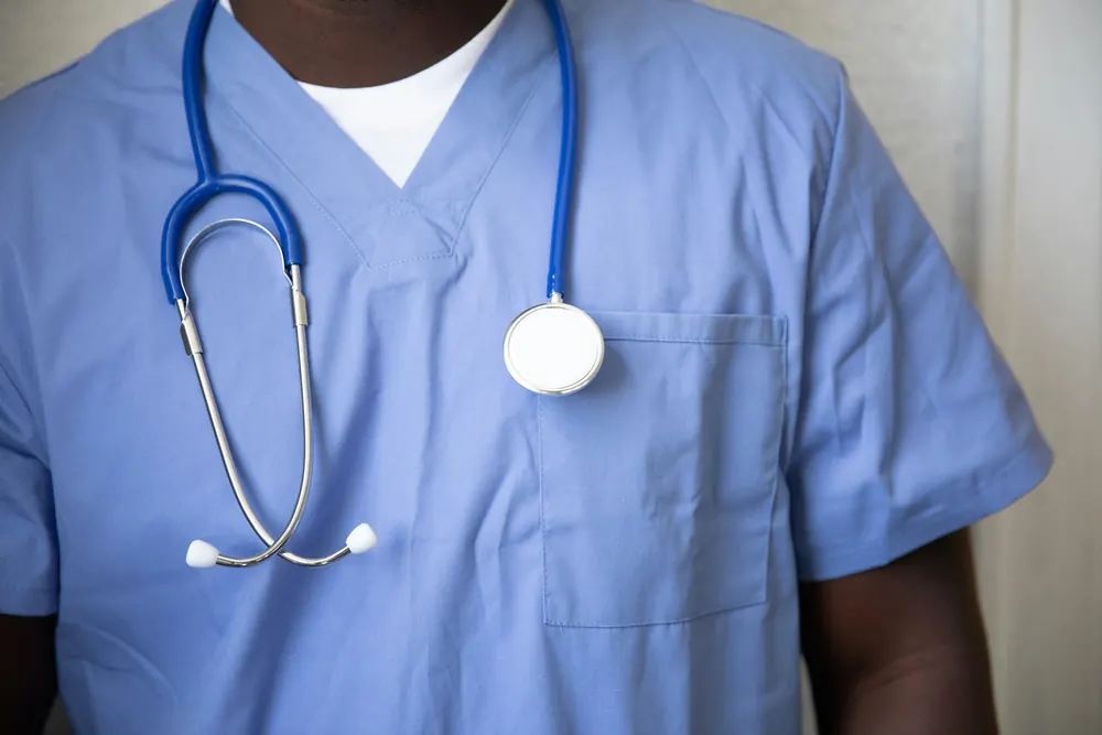 Healthcare worker in scrubs with a stethoscope