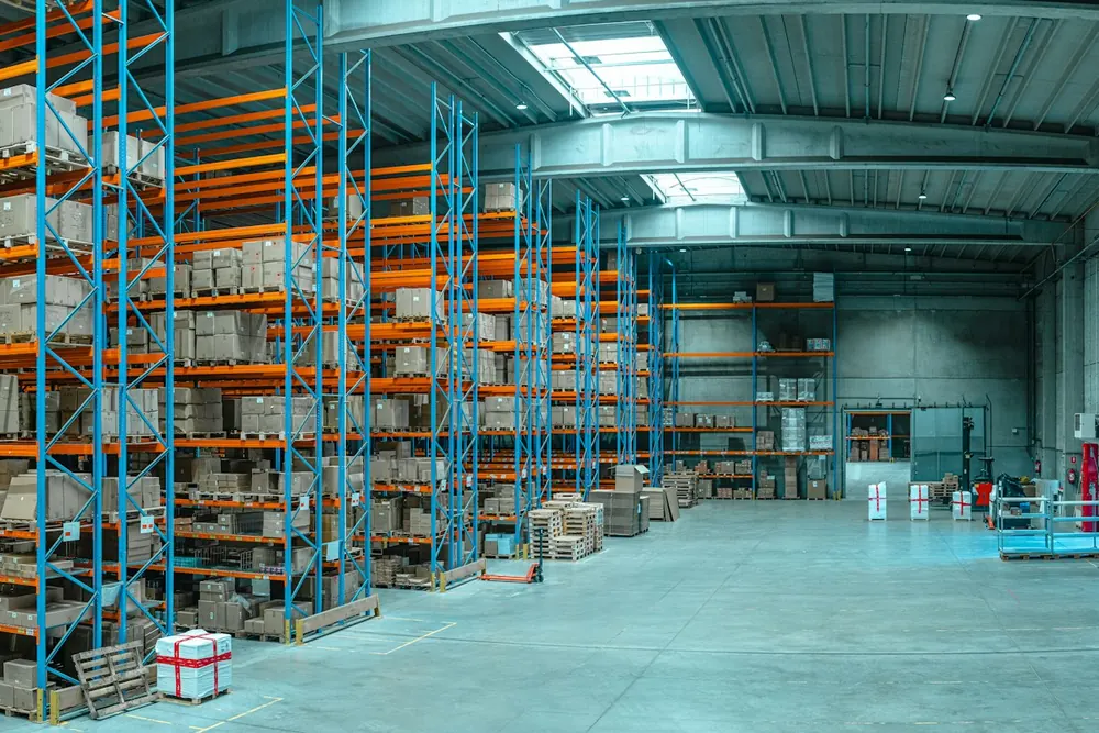 Warehouse aisles lined with stocked pallet racks