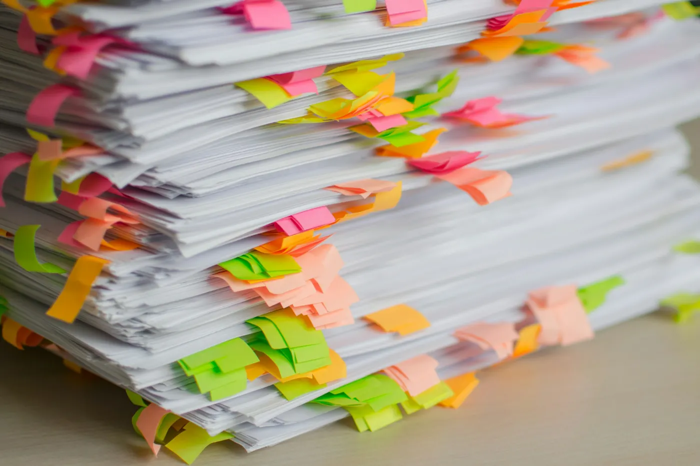 Stacks of paperwork organised with colourful index tabs